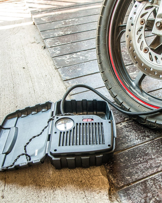 Portable air pump inflating a tire