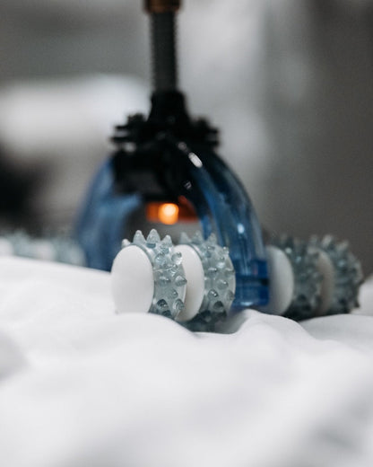 Massage device resting on soft white fabric